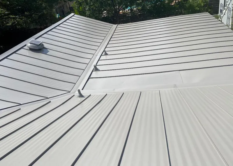 Solar attic fan installed on a metal roof for Roof Ventilation in Highland